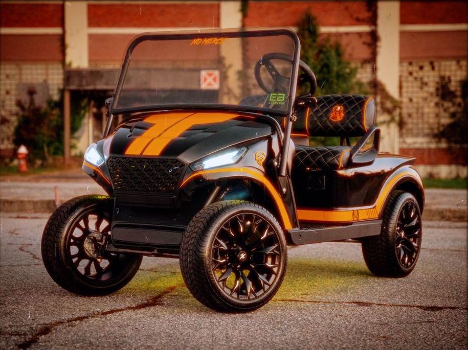 Black and gold Cobra Kai themed custom golf cart with Storm body kit and underglow