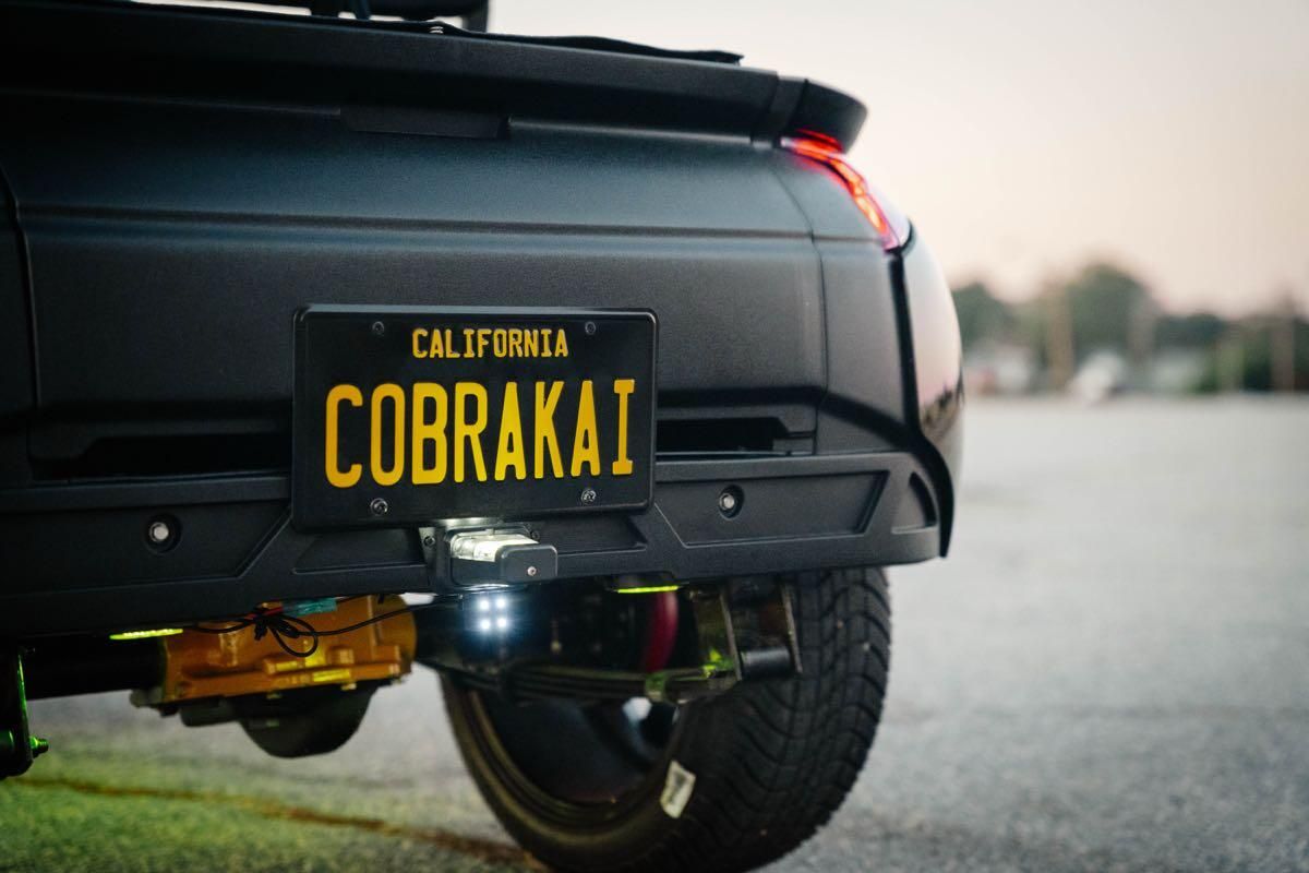 Cobra Kai California license plate on the rear of the cart